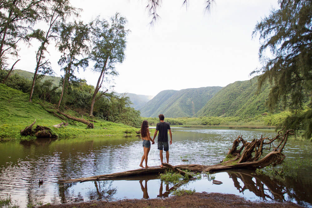couple hiking in Pololu Valley on Hawaii Island